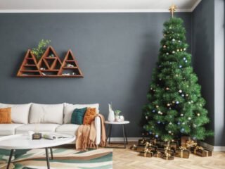 Large christmas tree and christmas presents in a modern living room.